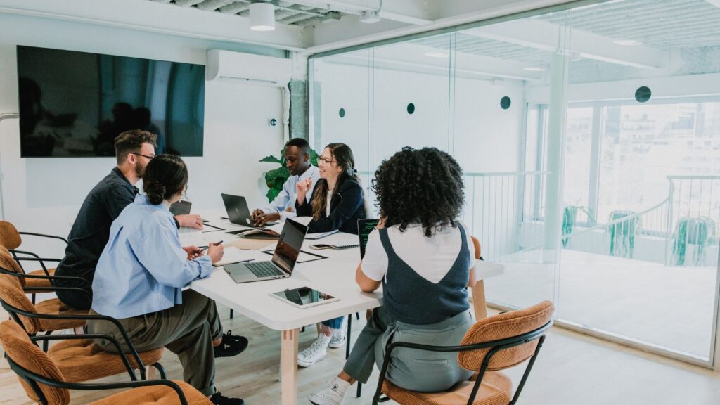 Corporate meeting in glass-walled boardroom