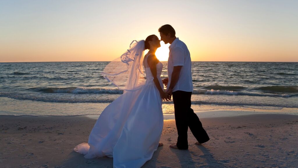 Bride and groom kissing on Punta Mita beach at sunset